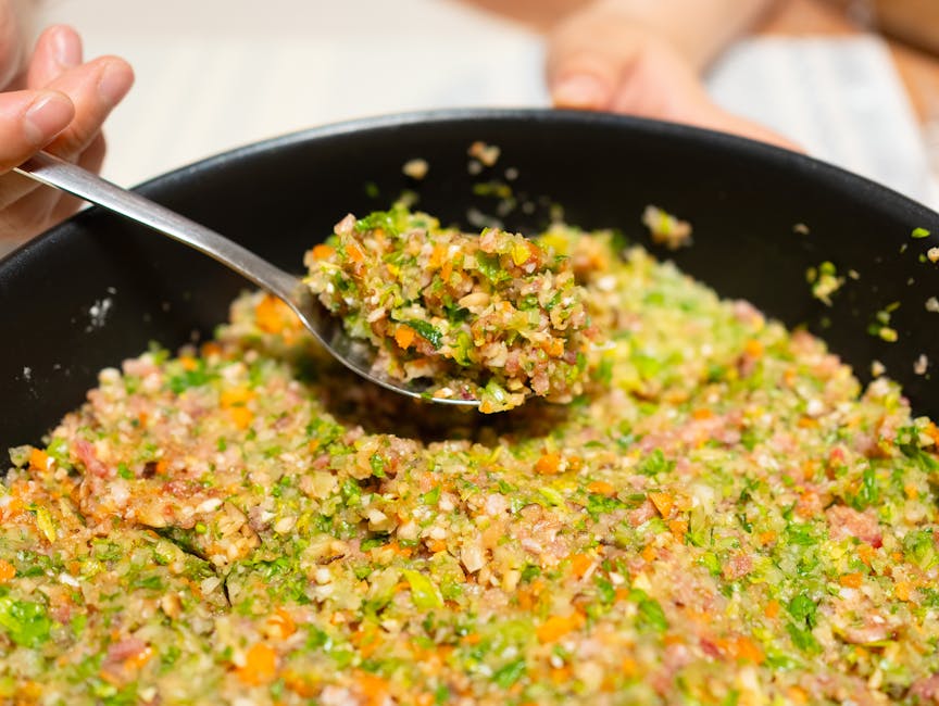 Close-up of a fresh and colorful vegetable stir fry being served from a pan, highlighting vibrant ingredients.