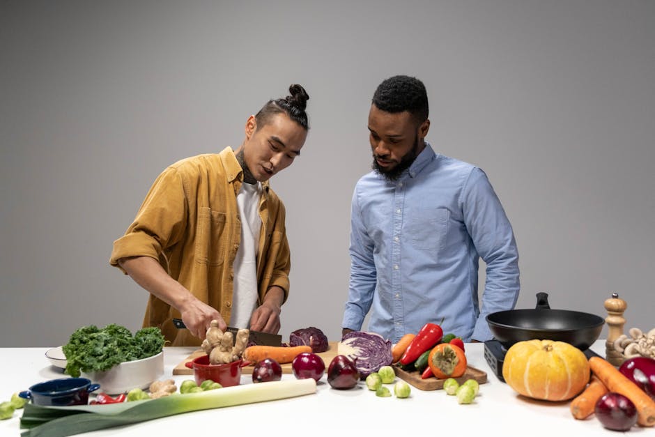 Two men preparing fresh vegetables, showcasing healthy vegan food options.