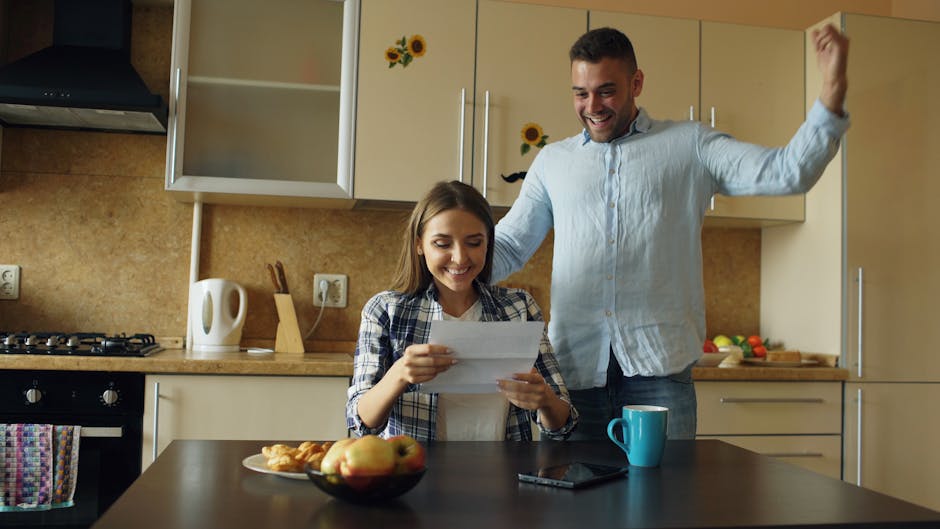 A joyful couple in a cozy kitchen, celebrating good news received by mail.